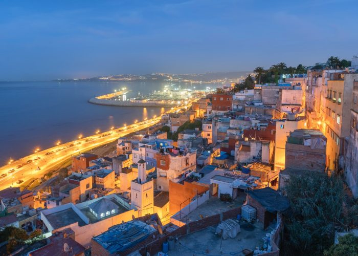 aerial view of city near body of water during night time