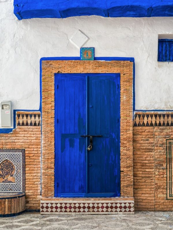 a blue and white building with a blue door