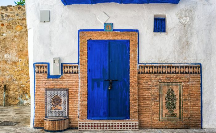 a blue and white building with a blue door