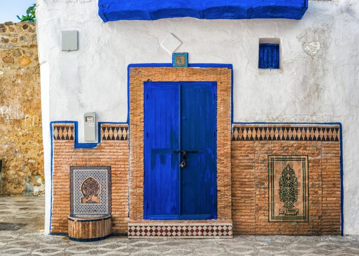 a blue and white building with a blue door
