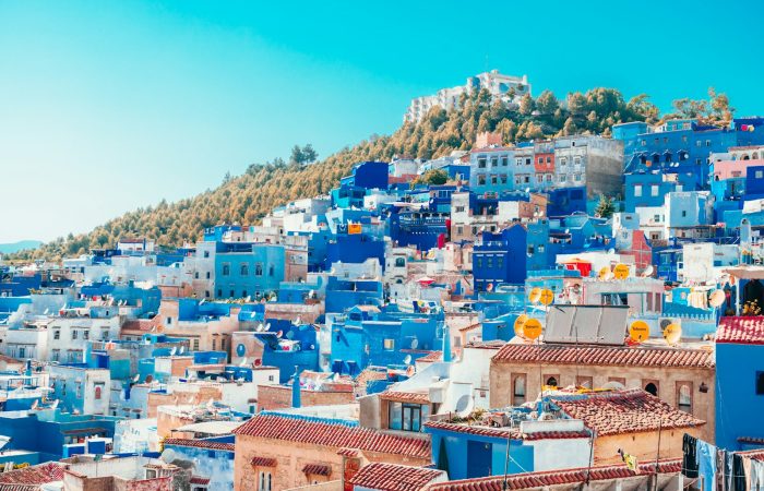 blue and white painted houses on the cliff