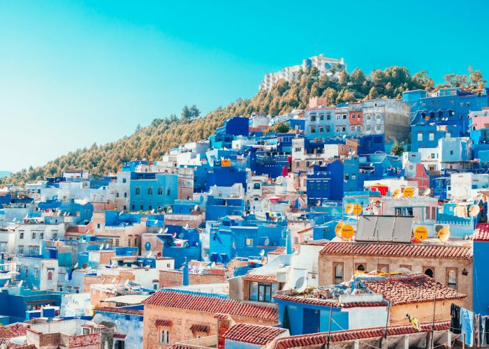 blue and white painted houses on the cliff